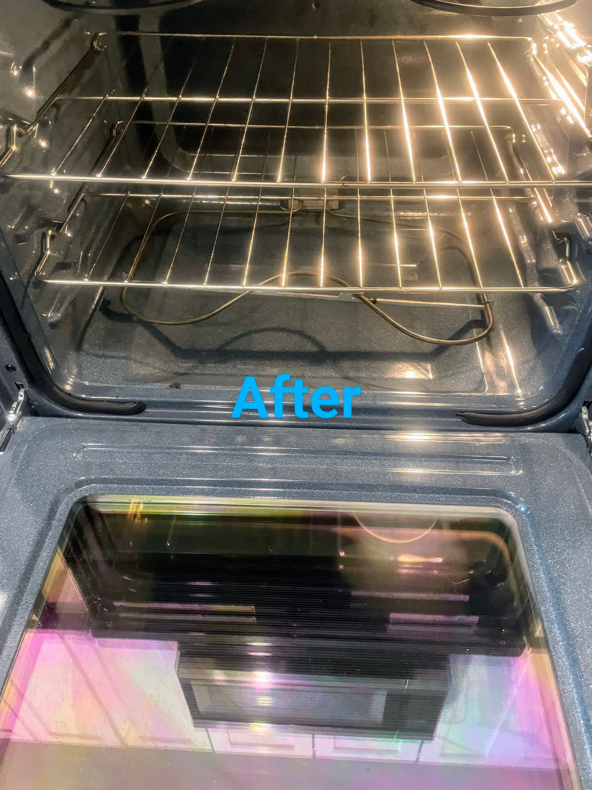 Clean oven interior with metal racks and glass door, labeled 