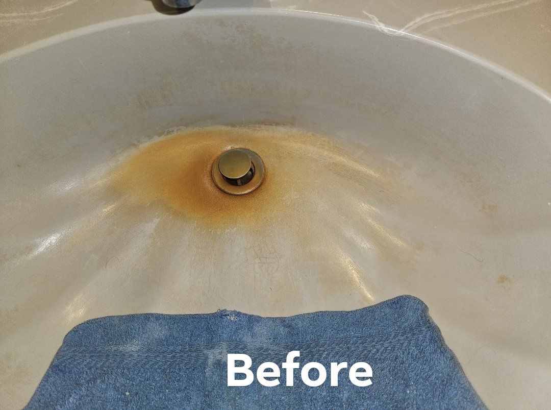 A before picture of a bathroom sink with a blue towel in it
