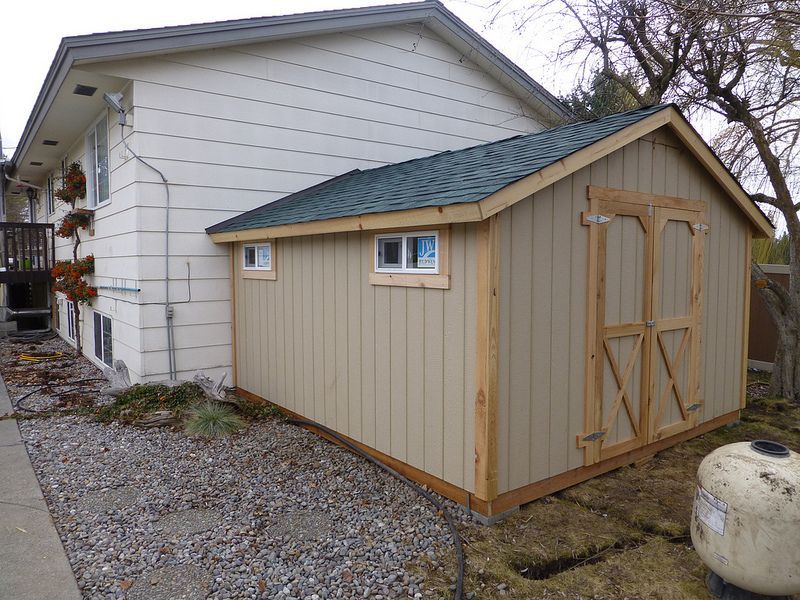 A shed is attached to the side of a house