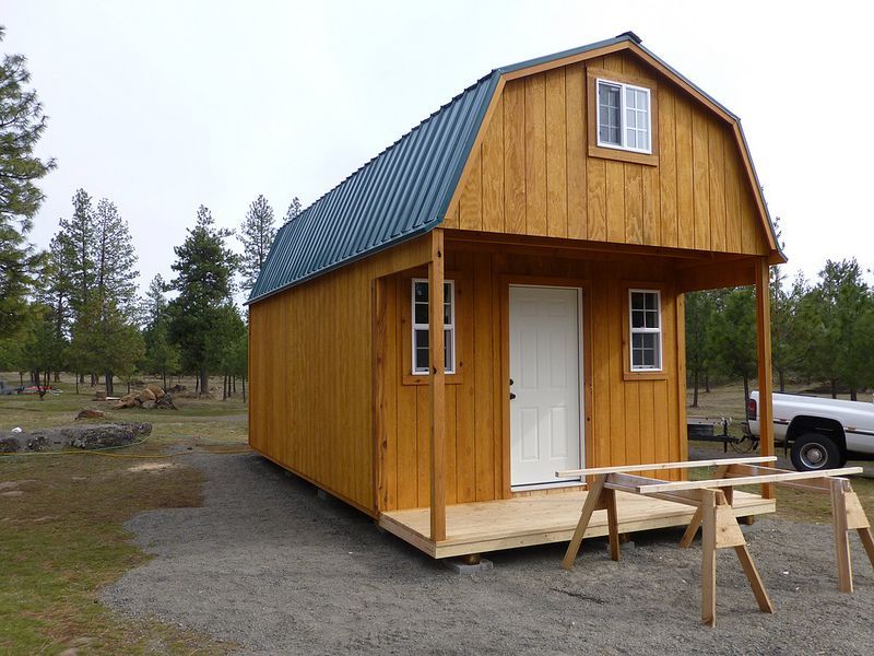 A small wooden house with a blue roof
