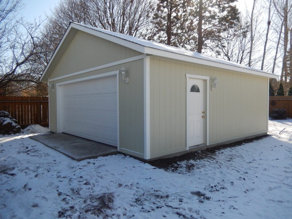 A garage with a roof that is covered in snow