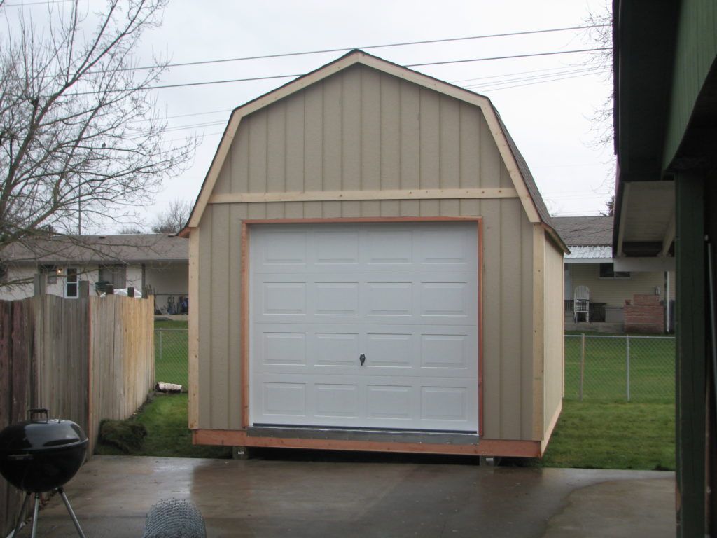 A barn style garage with a white garage door