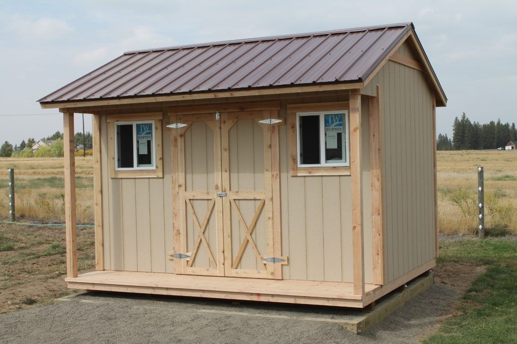 A small shed with a metal roof and a porch