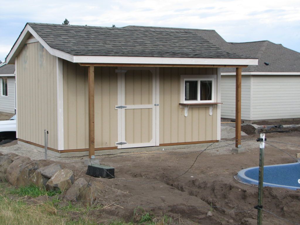 A small shed with a porch and a window