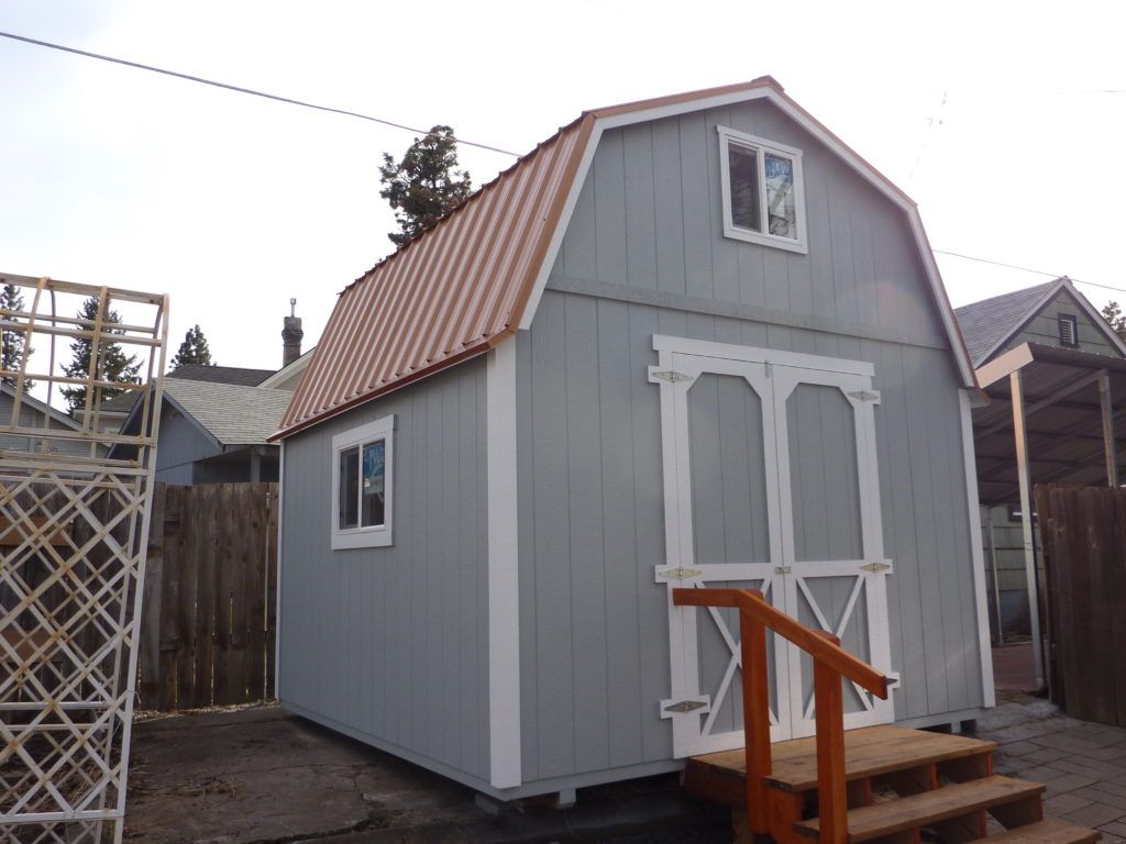 A small barn with stairs leading up to it