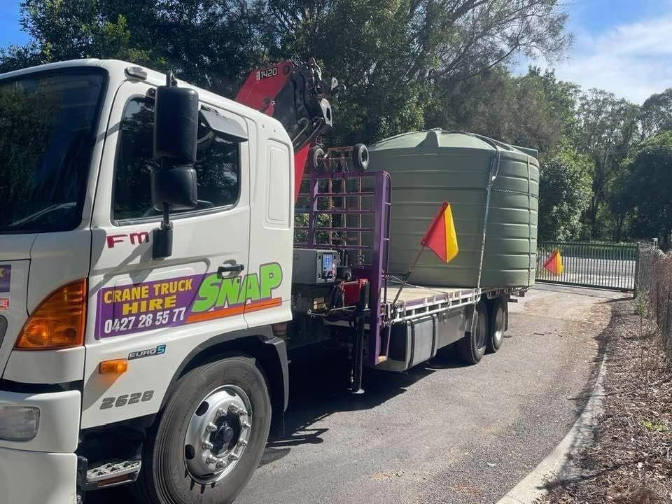 A White Truck With A Crane On The Back Is Parked On The Side Of The Road — Snap Crane Truck Hire in South Kempsey, NSW