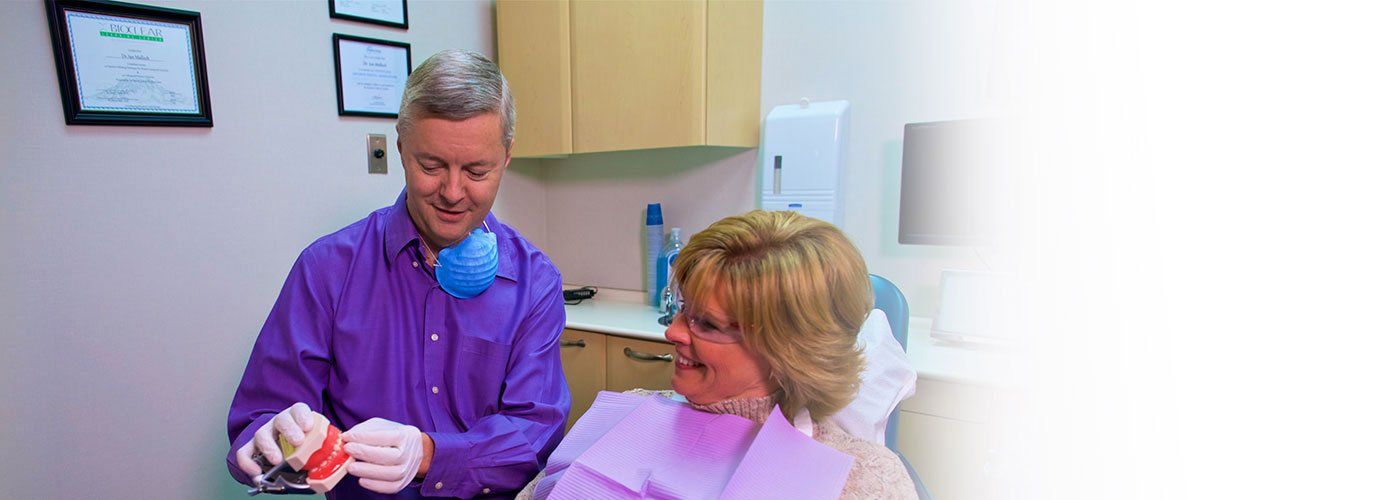 Dr Ian Malloch showing patient dentures