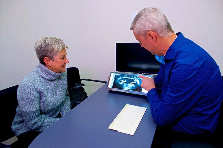 dentist showing patient image on a tooth, westend dental associates