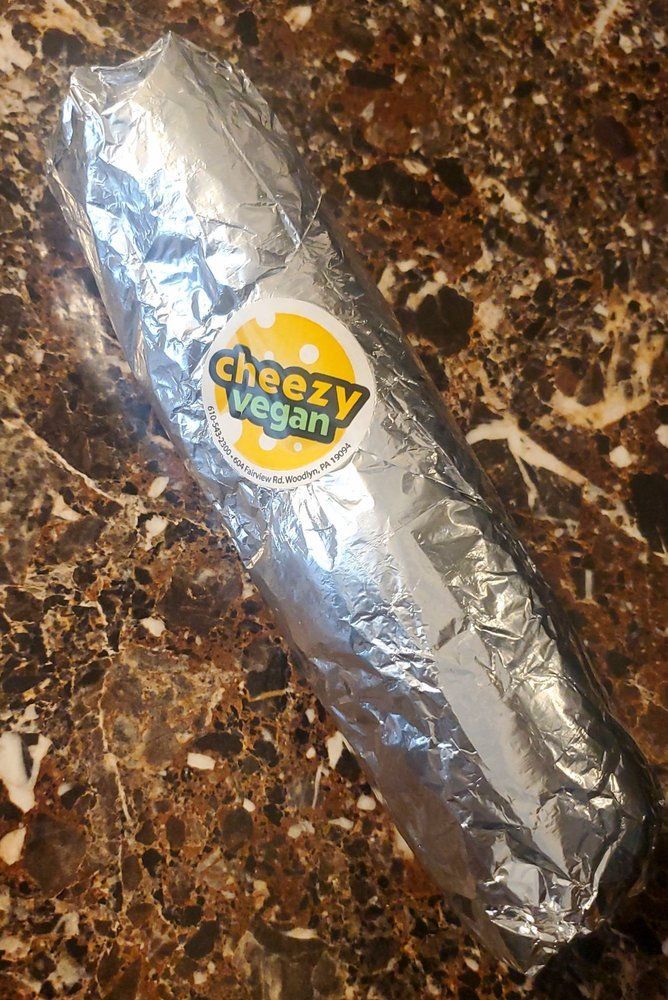 A foil-wrapped vegan burrito with a