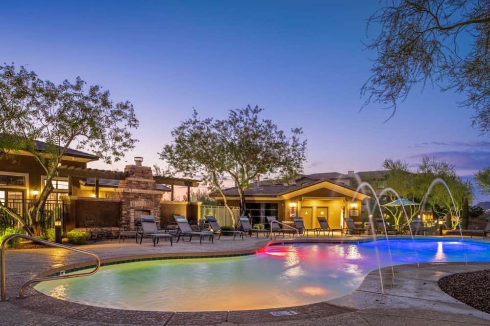 Beautiful outdoor swimming pool with colorful lighting at Marquis Sonoran Preserve in Norterra Phoenix, AZ.