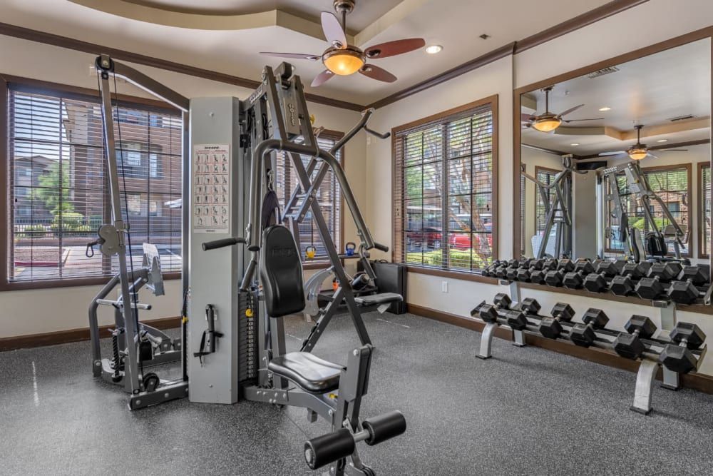 Fitness center with a lot of exercise equipment and a ceiling fan at Marquis Sonoran Preserve in Norterra Phoenix, AZ.