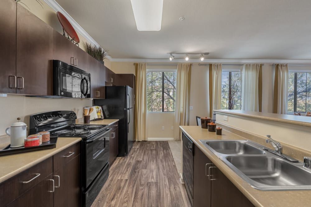 Modern kitchen with a sink, stove, microwave and refrigerator at Marquis Sonoran Preserve in Norterra Phoenix, AZ.