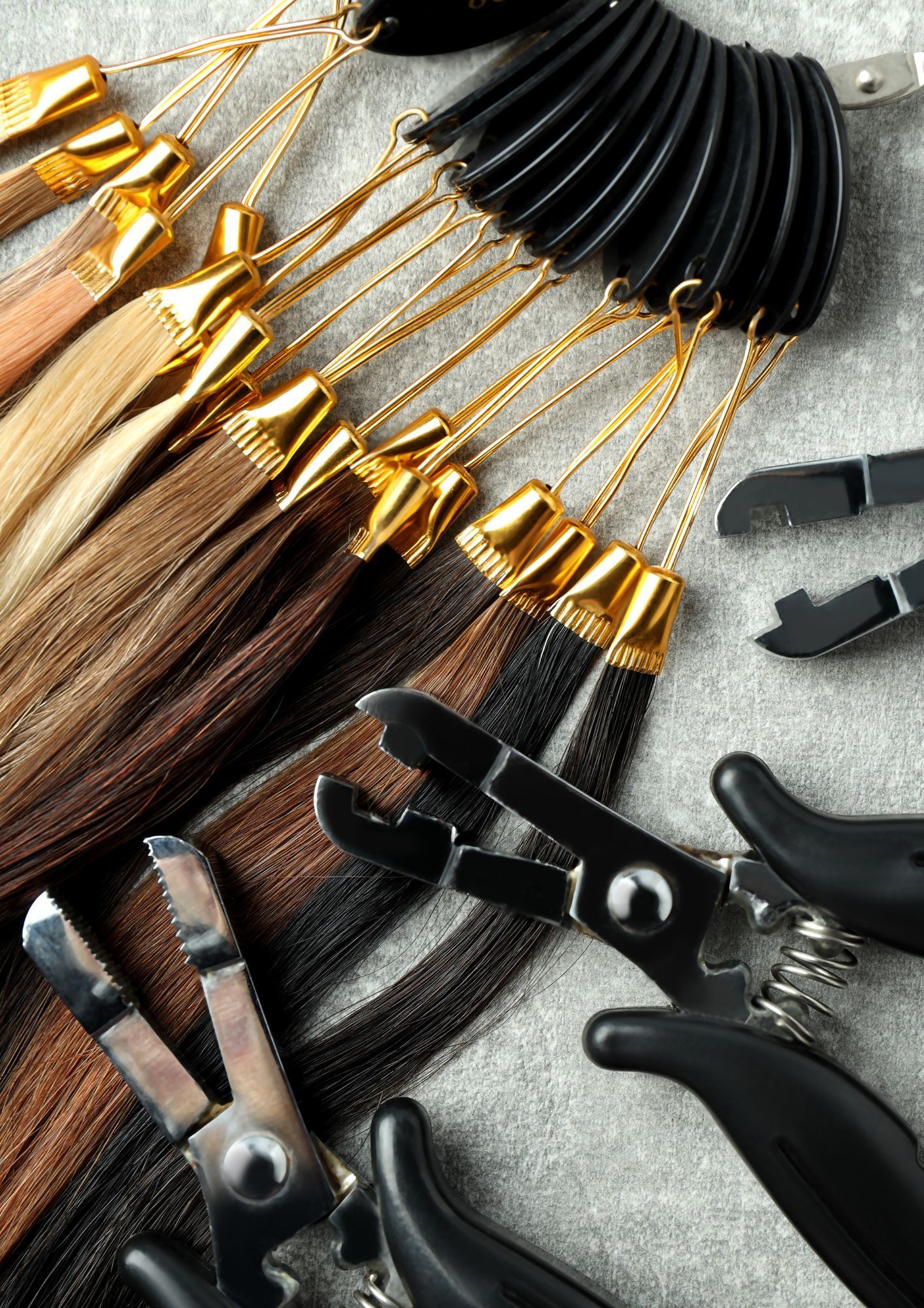 A bunch of hair extensions and hair extensions tools on a table.