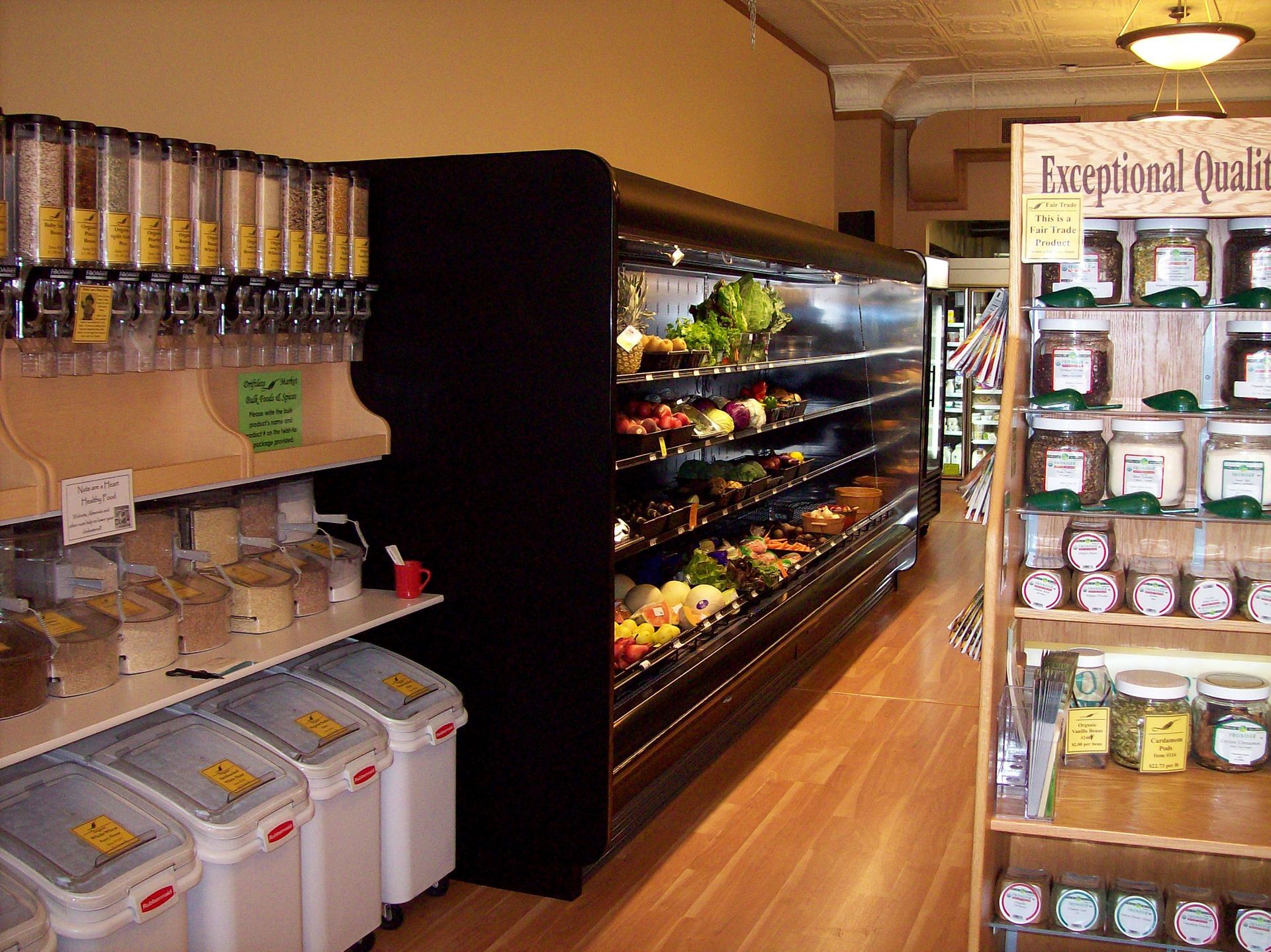 A man is repairing a refrigerator in a kitchen.