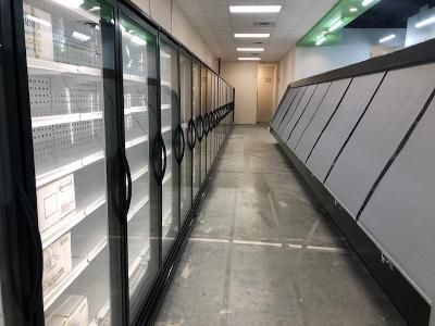 A stainless steel machine is sitting in a kitchen next to a sink.