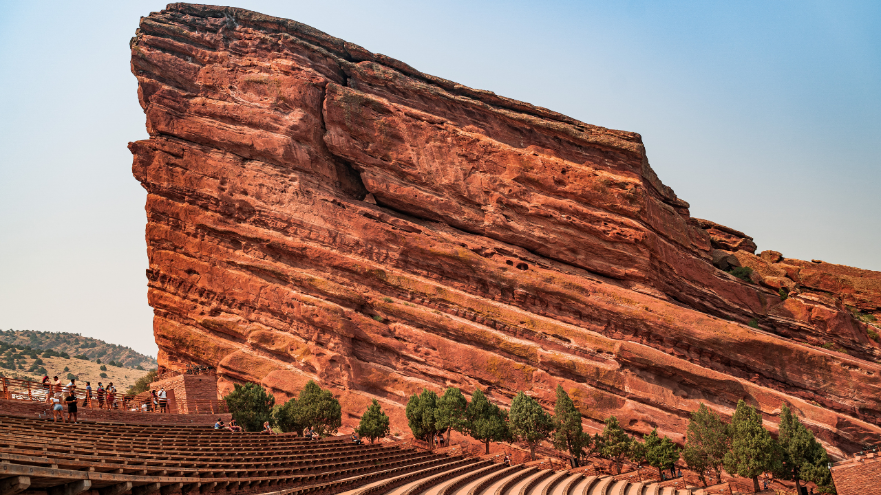 A large rock formation with a amphitheater in front of it.