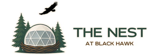A logo for the nest at black hawk a luxury outdoor resort
