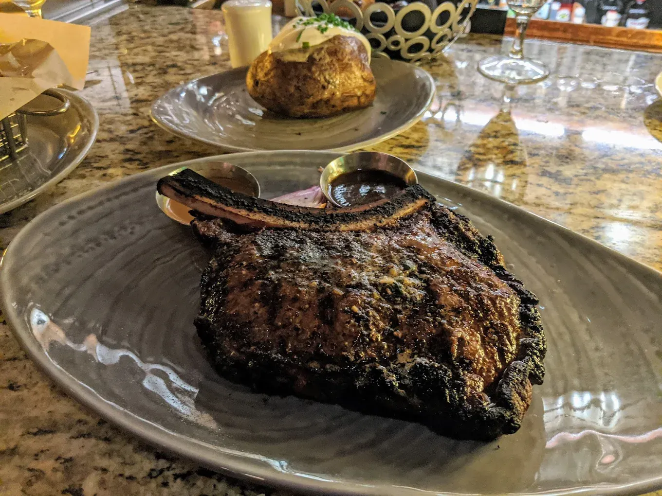 A large piece of meat is on a plate on a table.