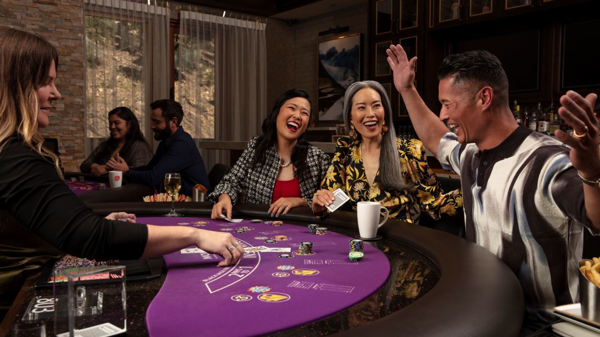 A group of people are playing a game of blackjack at a table.