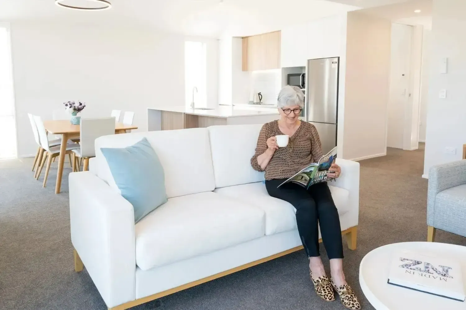Resident relaxing with coffee in apartment