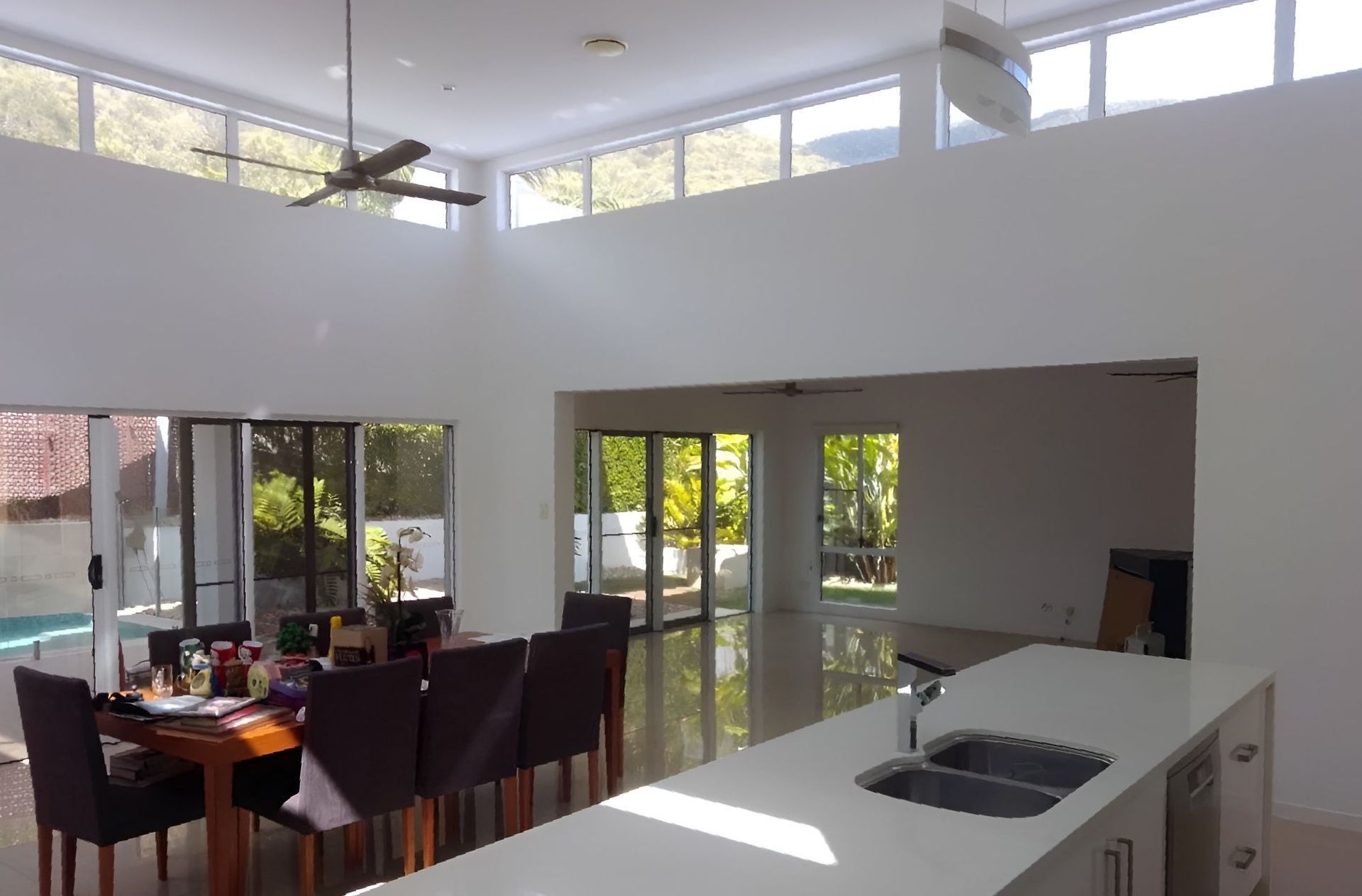 An Empty Room With Hardwood Floors And A Ceiling Fan — Kiwi Painter In Mooroobool, QLD