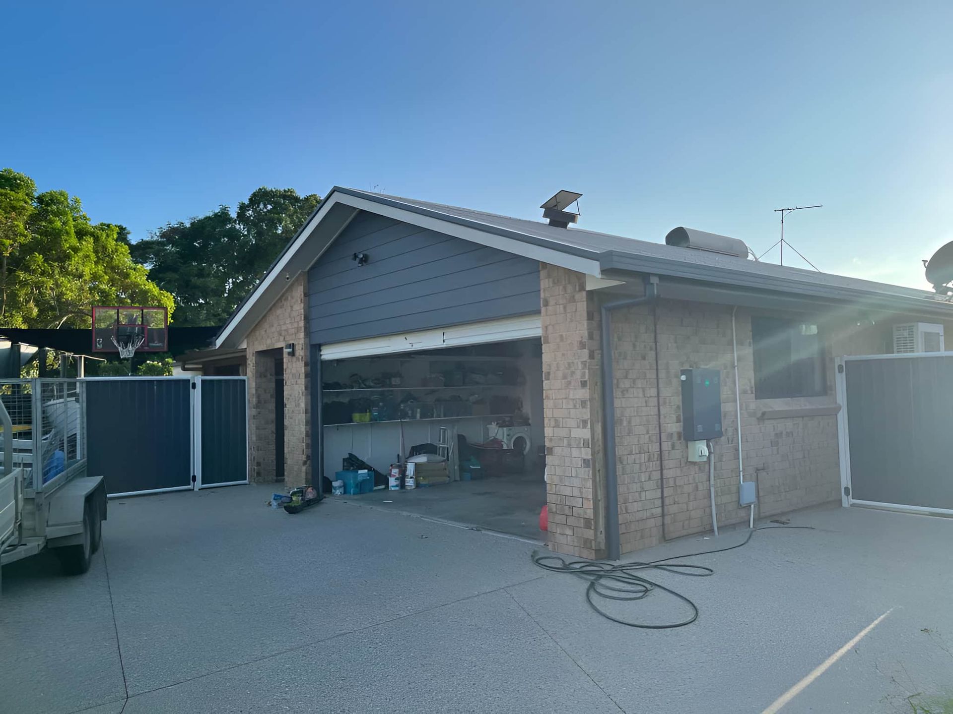 A Brick House With A Garage And A Fence In Front Of It — Kiwi Painter In Mooroobool, QLD