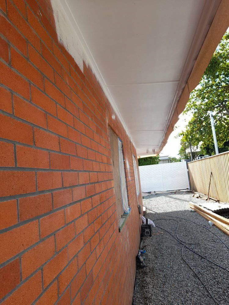 A Brick Wall Is Being Painted With White Paint — Kiwi Painter In Port Douglas, QLD