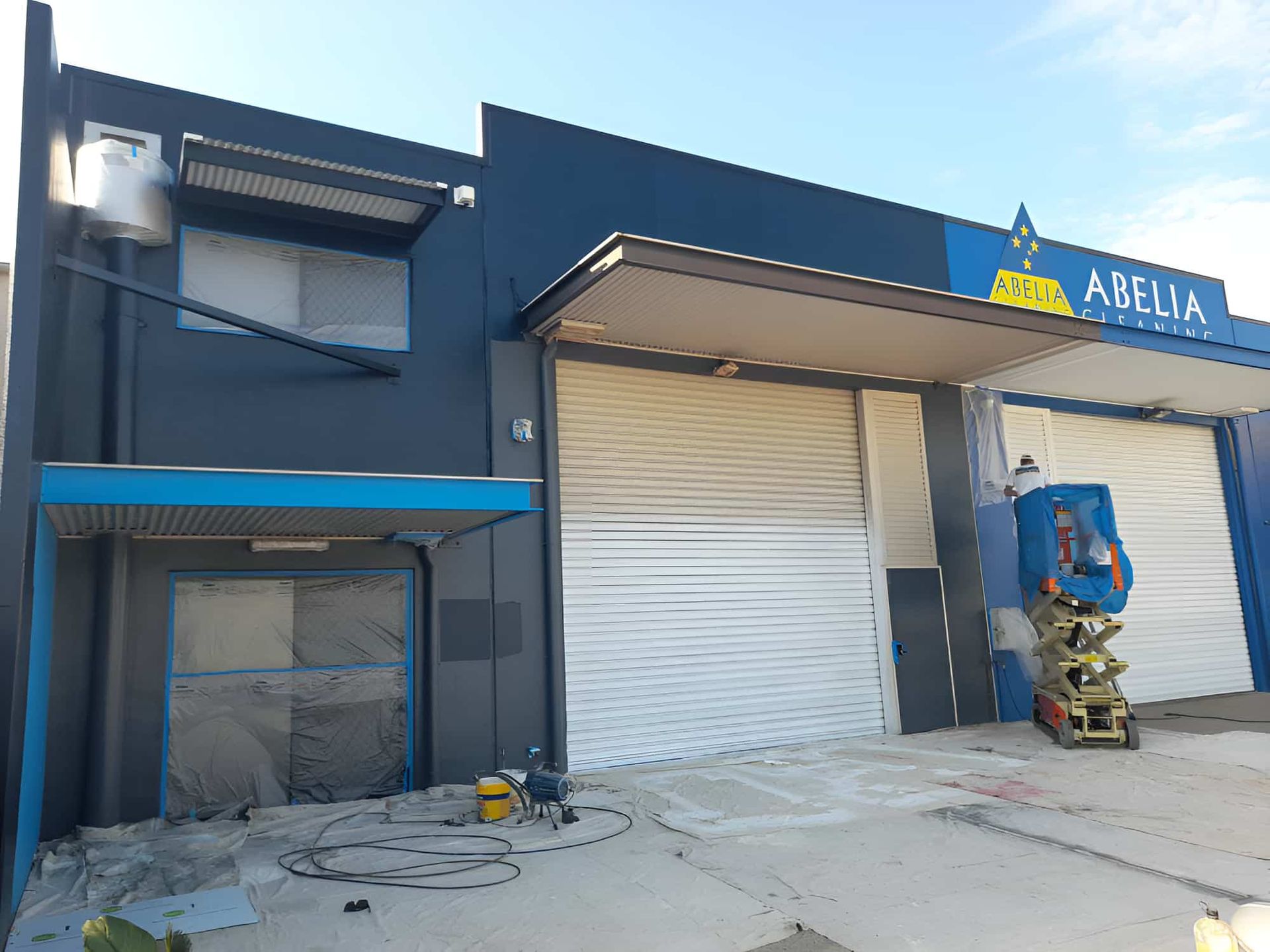 A Building With A Sign That Says' Adelphia' On It Is Being Painted — Kiwi Painter In Mooroobool, QLD