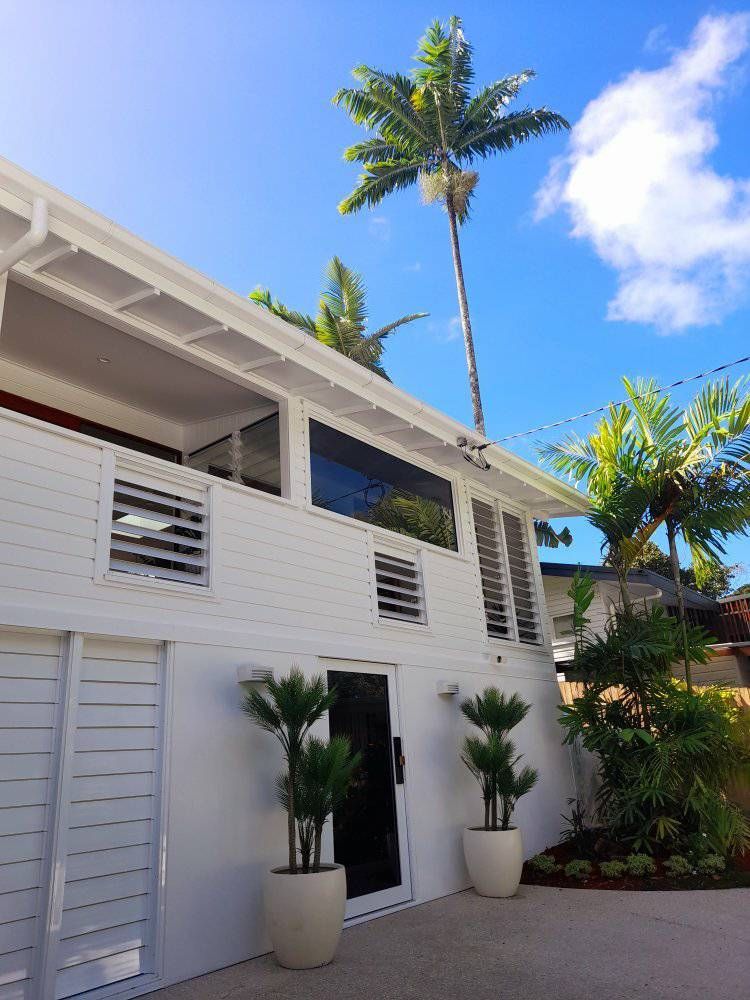 A Large Empty Room With Hardwood Floors And White Walls — Kiwi Painter In Mooroobool, QLD