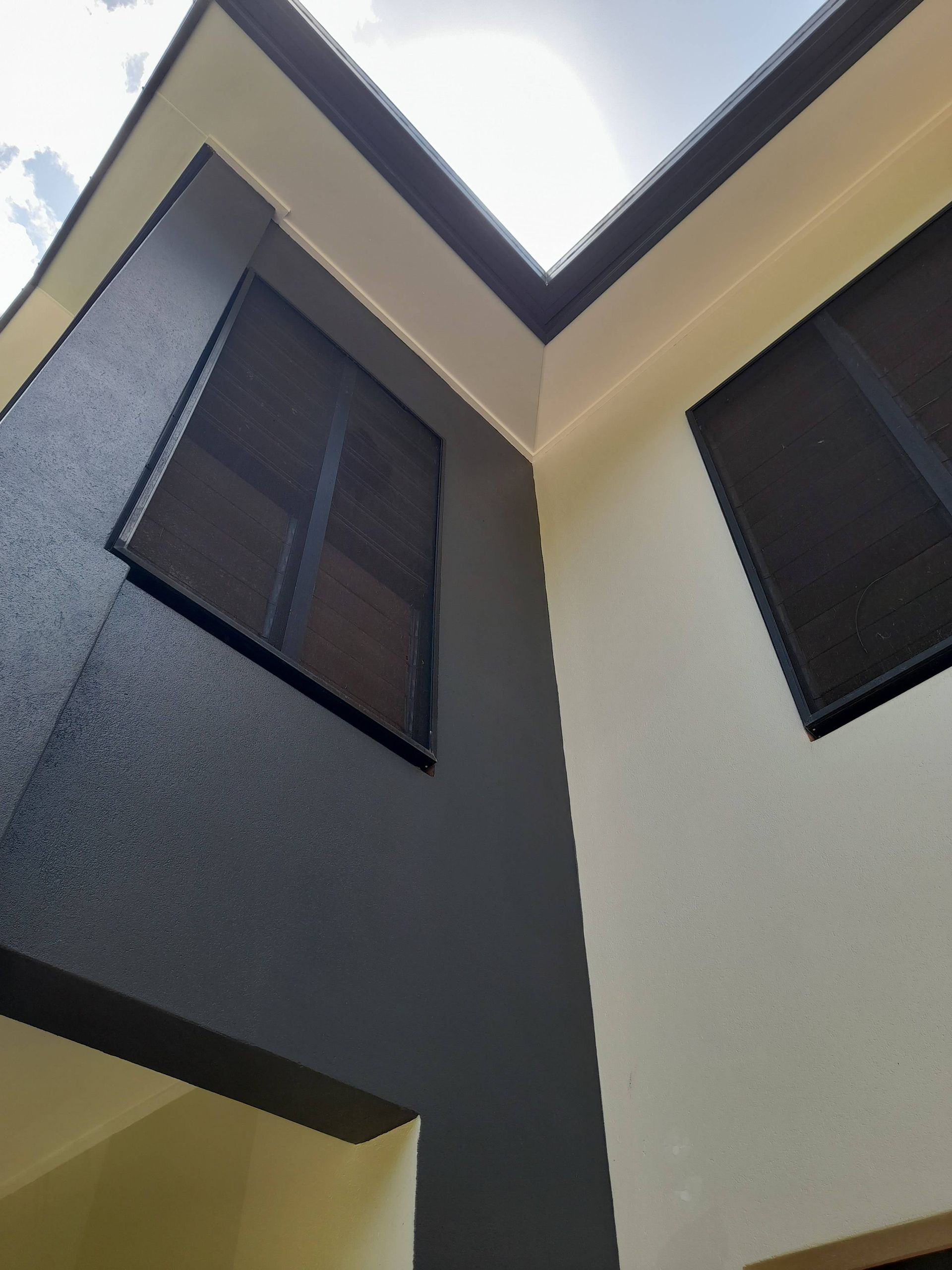 A house with a carport and a ladder in front of it. — Kiwi Painter In Mooroobool, QLD