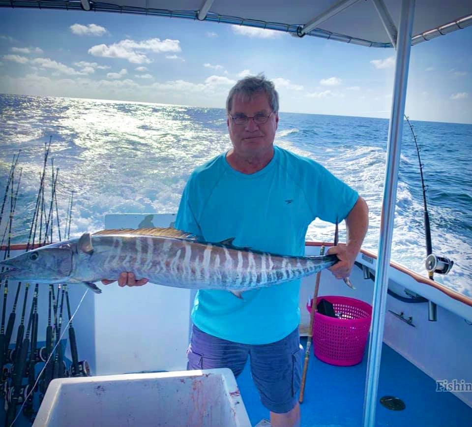 A full moon is shining over the ocean at night A full moon is shining over the ocean at night advertising night fishing with Reel Groovy Experiences.