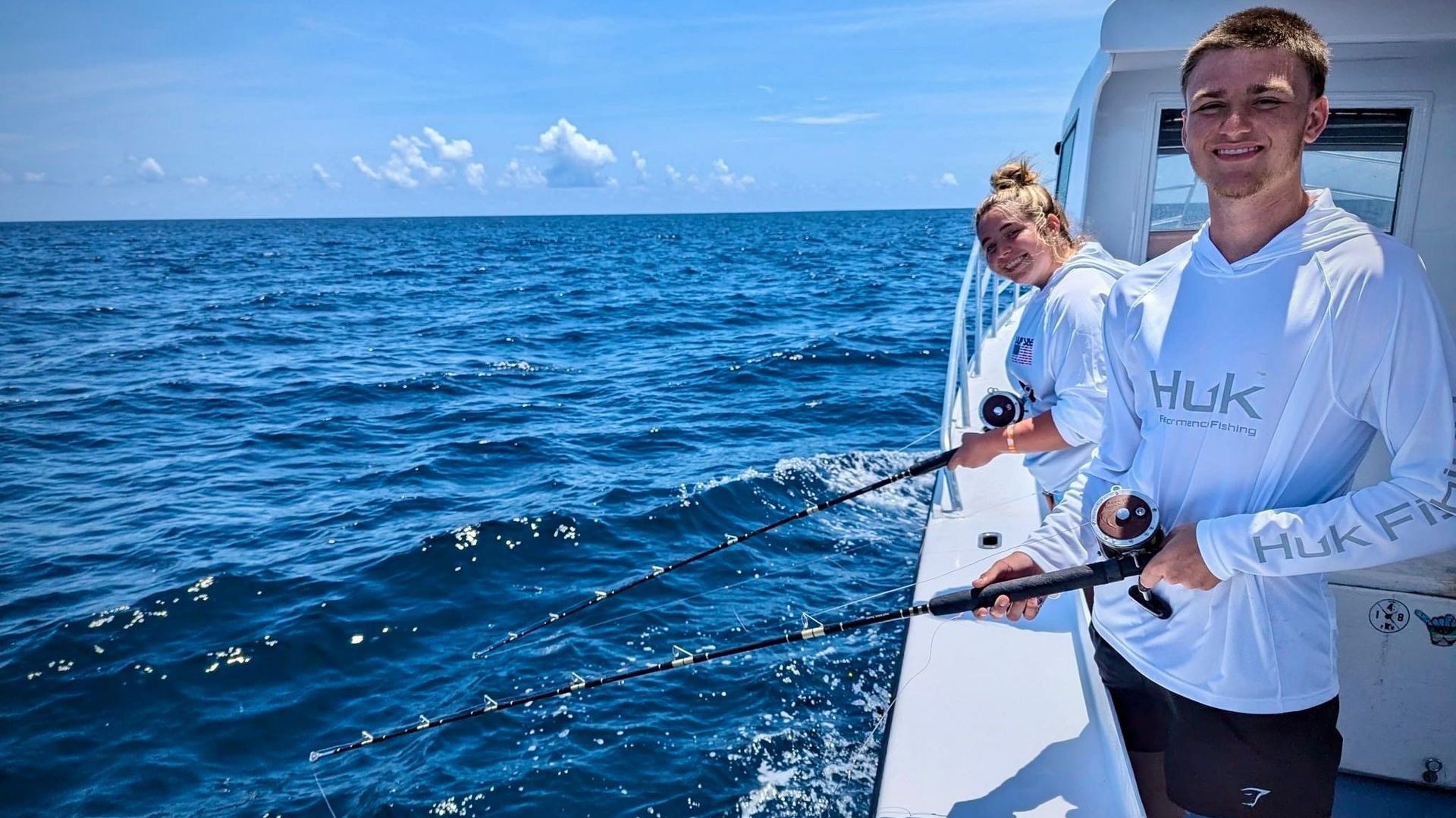 Couple on private deep sea fishing charter Panama City Beach with Reel Groovy