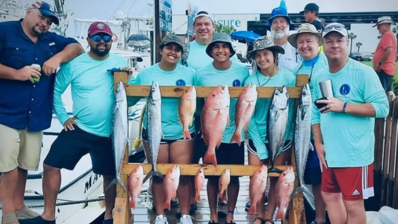 Group with rack of fish after fishing charter Panama City Beach with Reel Groovy