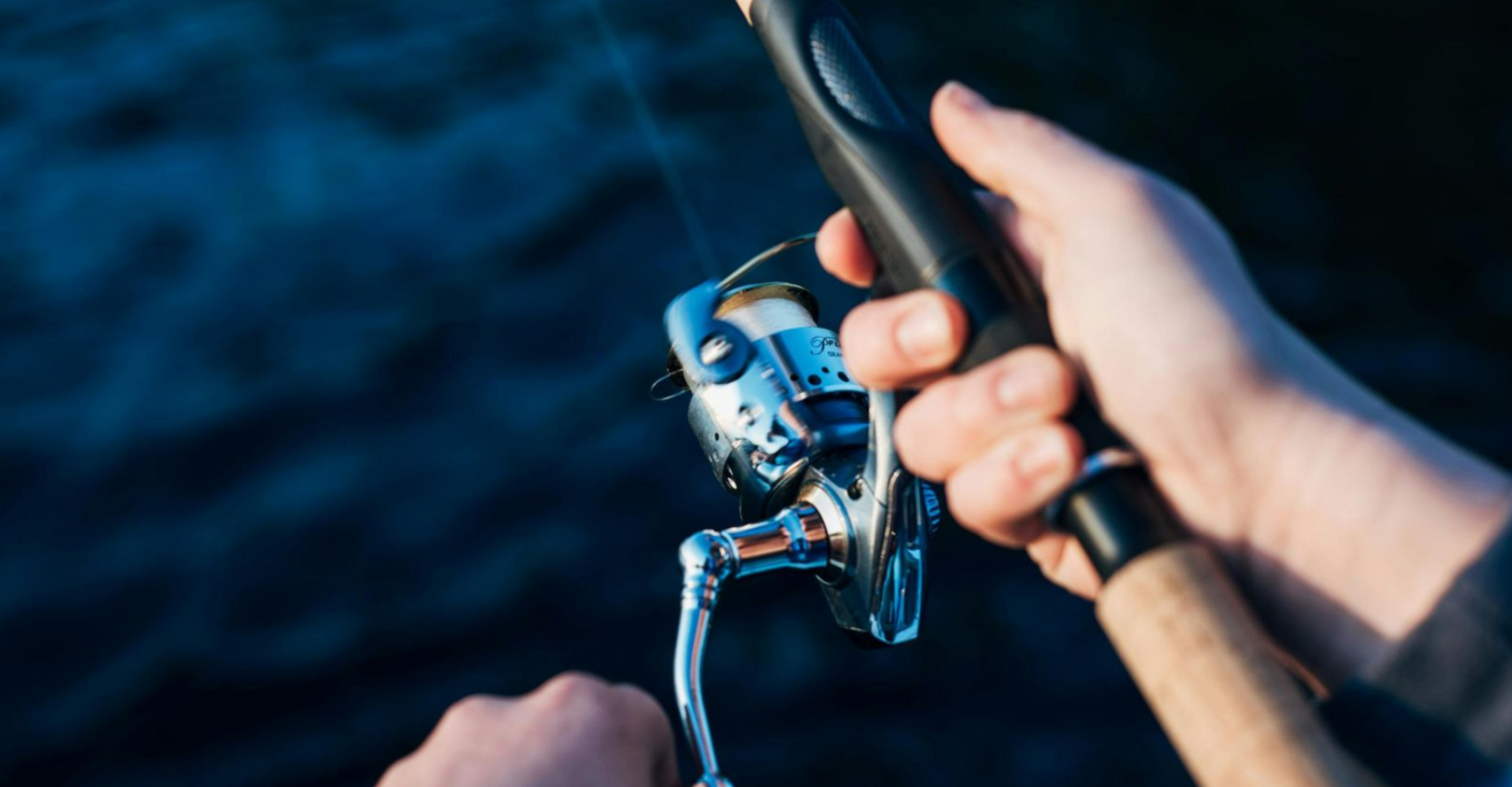 Person holding a fishing rod, ready to cast during a fishing charter Panama City Beach.