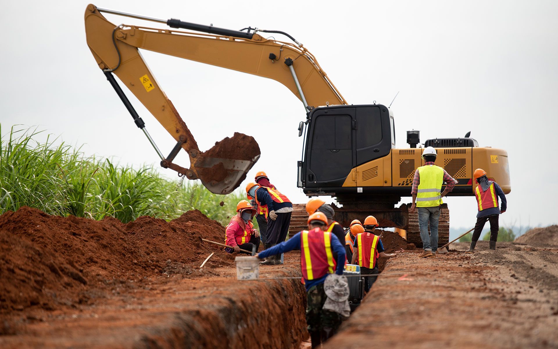A group of construction workers are working on a construction site.