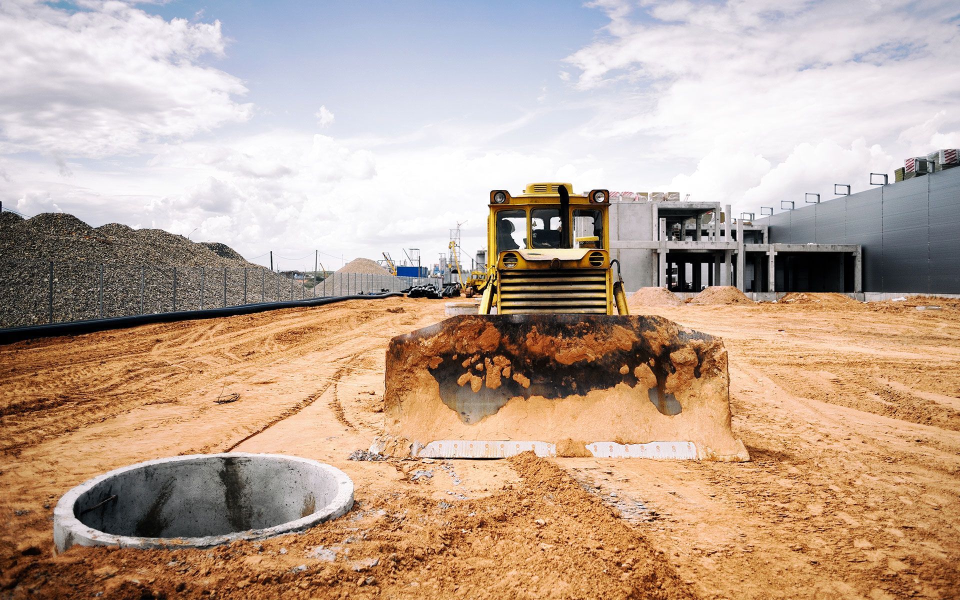A bulldozer is moving dirt on a construction site.