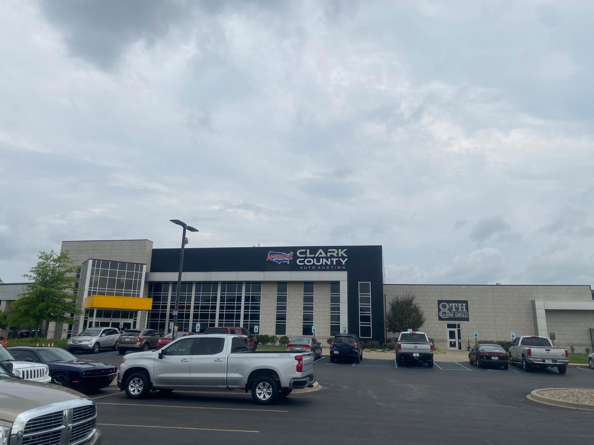 A large building with a lot of cars parked in front of it.
