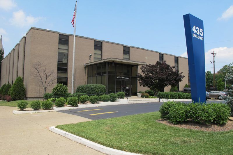 A large brown building with a blue sign that says 435