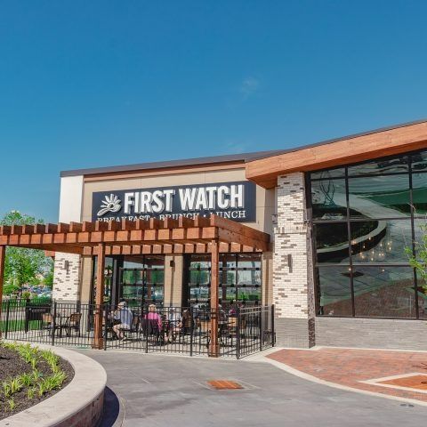A large building with a sign that says first watch on it