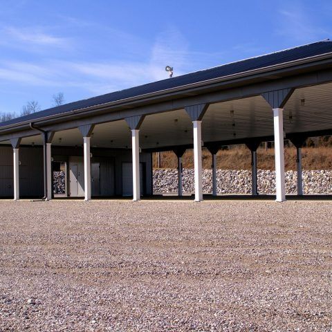 A covered area with columns and a blue sky in the background