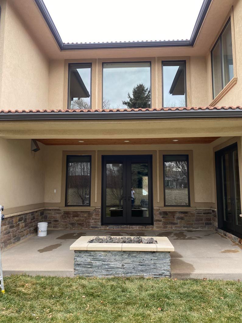 A large house with a fire pit in front of it