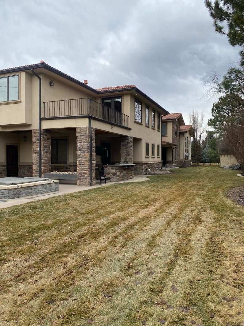 A large house with a large lawn in front of it.