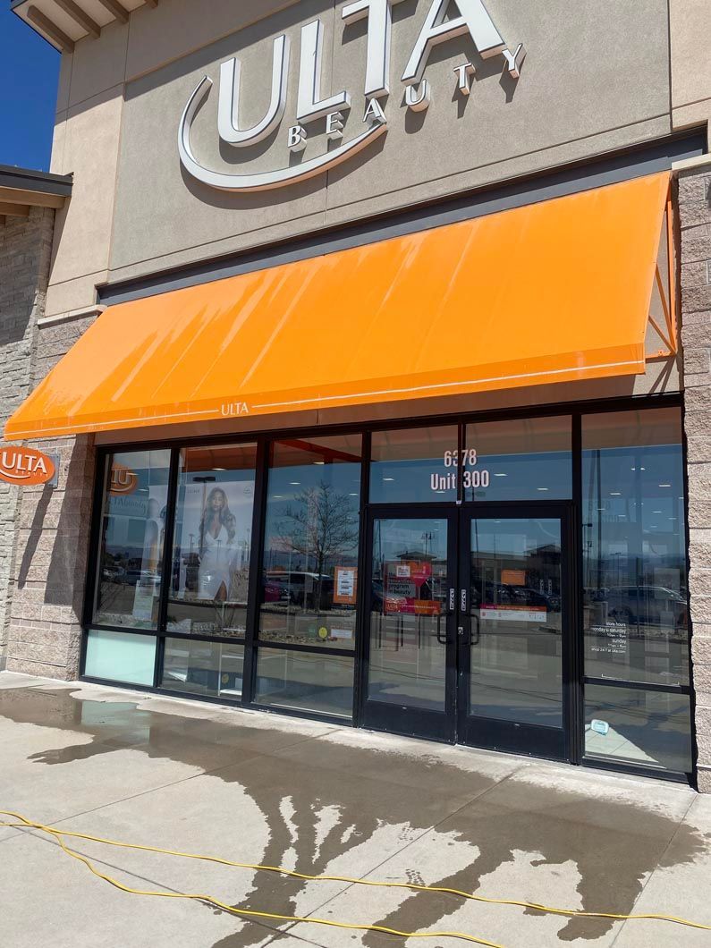 A store front with an orange awning and a sign that says ulta