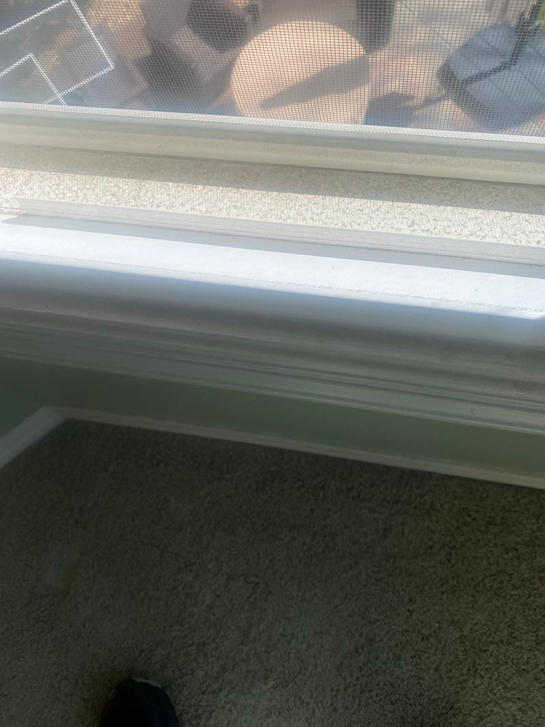 A close up of a window with a screen on it in a room.