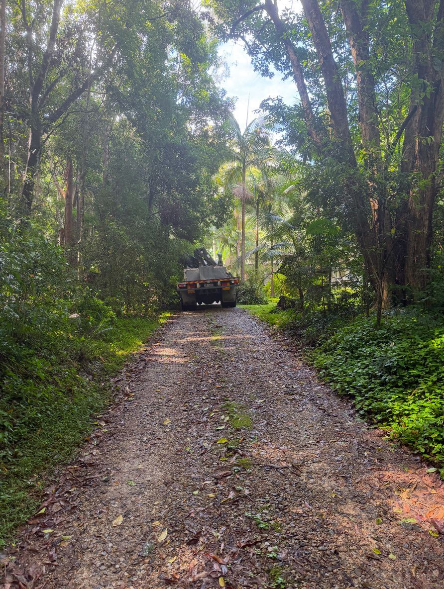 A Truck Driving Down a Driveway — Brodees Crane Trucks in Murwillumbah, NSW