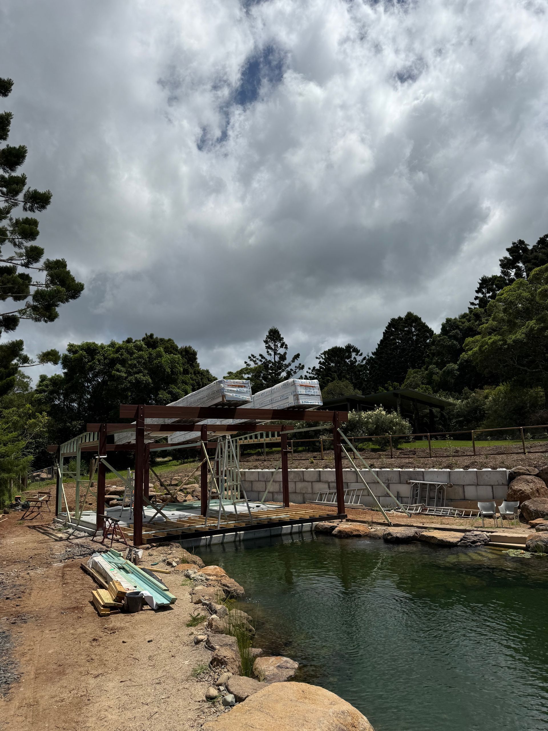 A Steel Frame is Sitting Next to a Pond — Brodees Crane Trucks in Gold Coast, NSW