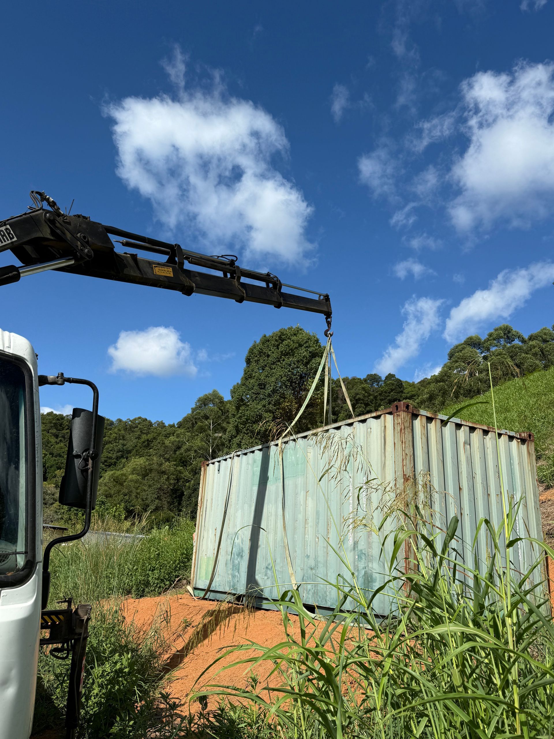 A Crane Truck Picking up a Container— Brodees Crane Trucks in Burleigh, NSW