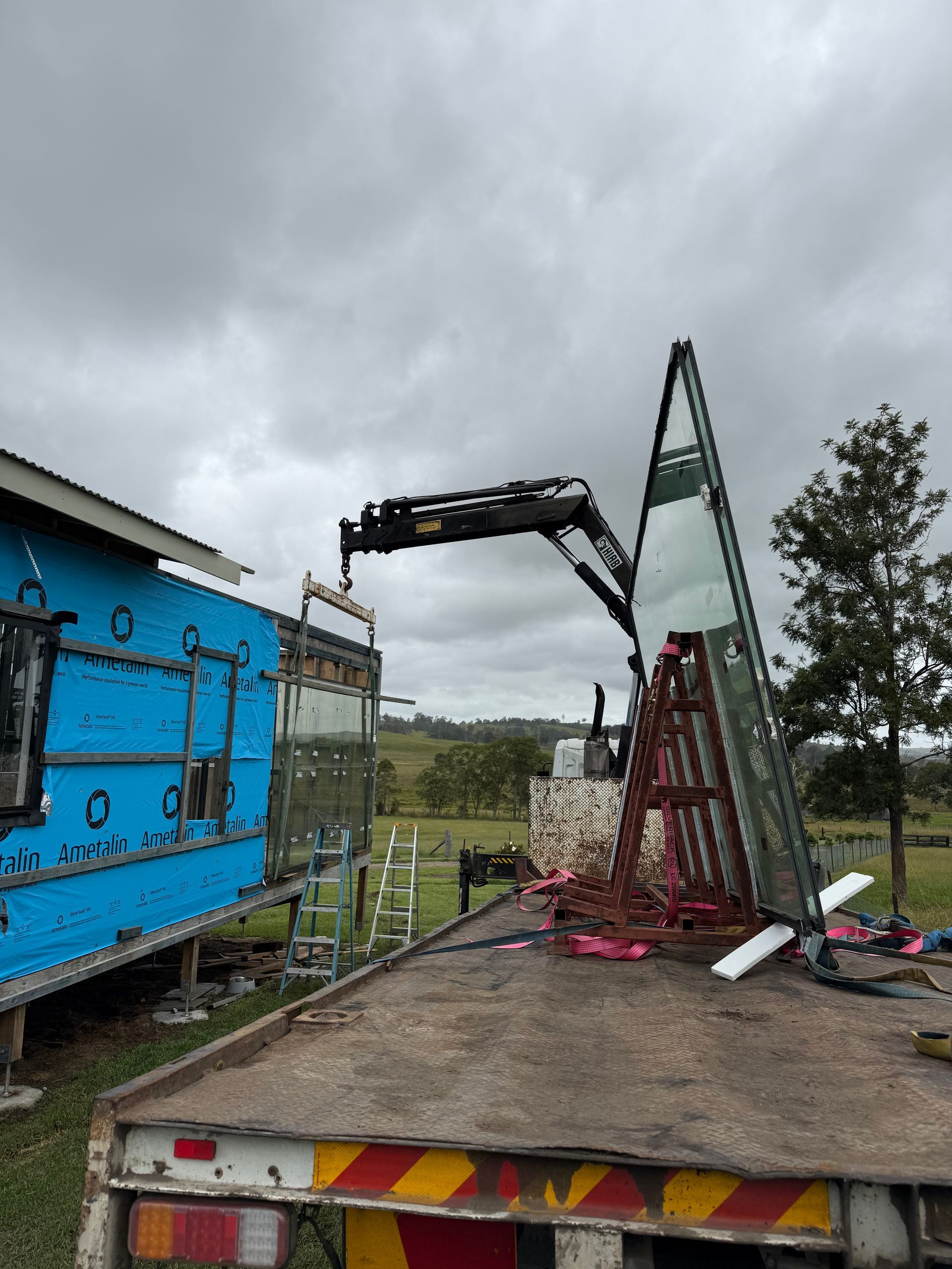 A Crane Truck is Transporting Glass — Brodees Crane Trucks in Byron Bay, NSW