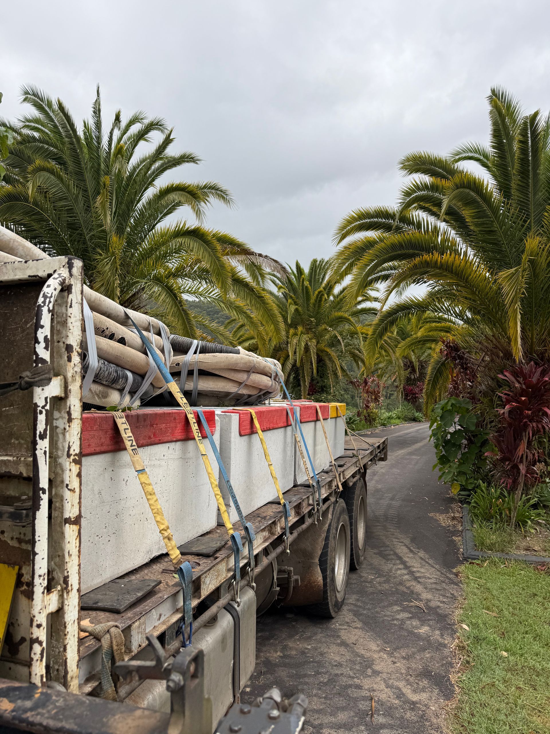 A Truck is Carrying Some Concrete Blocks and Pipes — Brodees Crane Trucks in Lismore, NSW