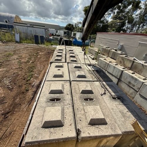 A Row of Concrete Blocks Are Being Lifted by a Crane — Brodees Crane Trucks in Murwillumbah, NSW